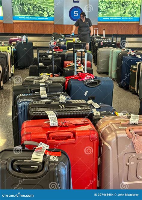 An Airline Employee Scans Unclaimed Baggage In Richmond International Airport Editorial